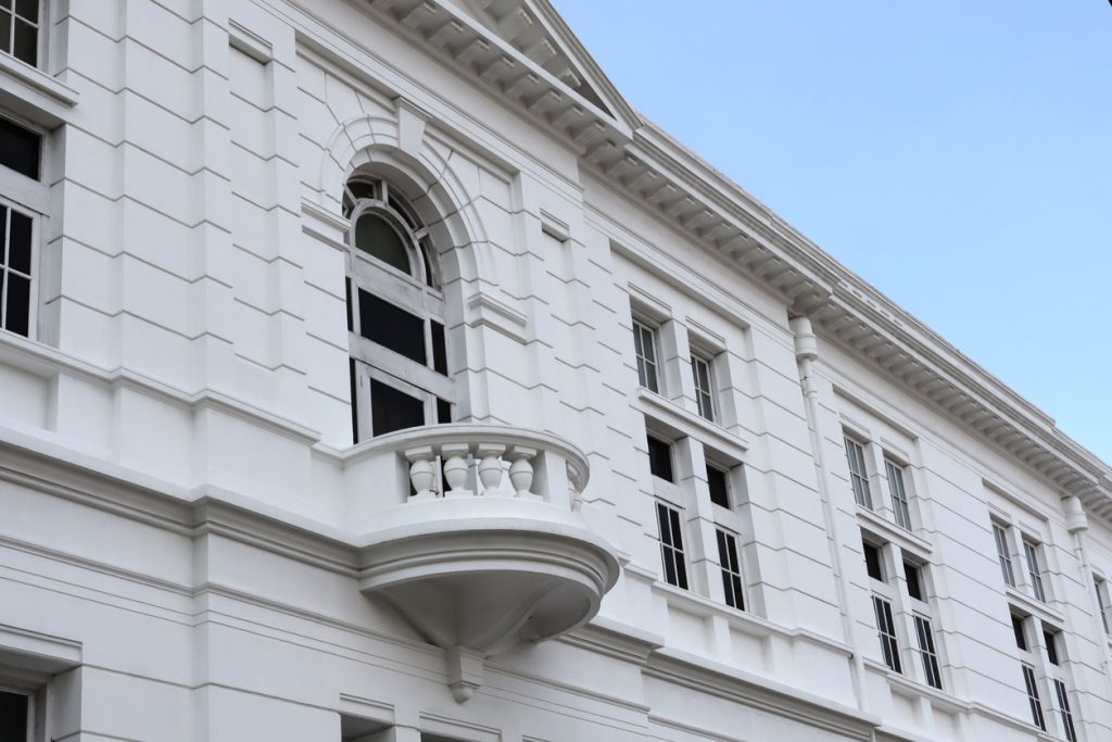 Uni-Shape mouldings installed around windows and balustrades on a facade